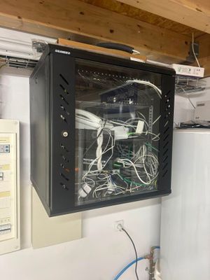 a wall mounted cabinet with a bunch of wires in it