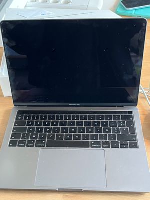 an apple macbook pro laptop computer sitting on top of a wooden table