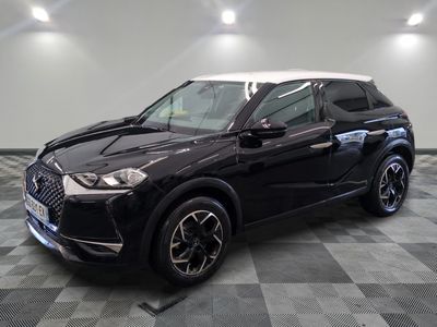 a black suv parked on a checkered floor in a garage