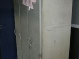 a white refrigerator in a room with a blue wall