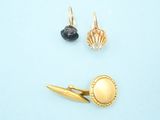 two pairs of earrings on a blue surface