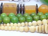 many different colored beads on a white table