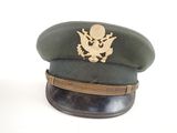 a green hat with a gold eagle on it