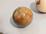 two eggs sitting on a table next to each other