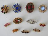 many different types of brooches on a white surface