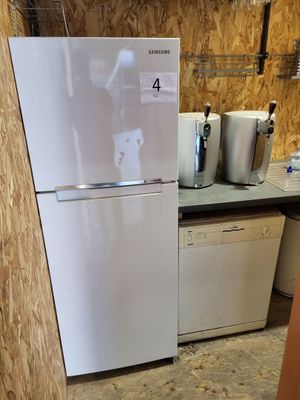 a white refrigerator in a kitchen with a lot of counter space
