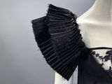 an image of a mannequin dress with black lace and ruffles