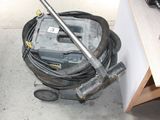 a vacuum that is sitting on the floor next to a table