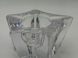 clear glass candle holder on a white surface with a white background