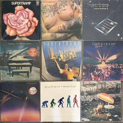 many different album covers on the table together