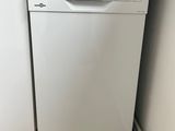 white dishwasher sitting in a kitchen next to a window