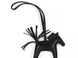 black leather horse ornament with tassels hanging from it ' s neck