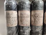 several bottles of wine are lined up in a row