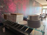 several stacks of pizza stacked on top of each other on a table
