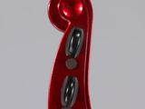 close up of a red violin with a white background