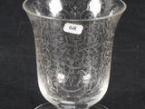 an image of a clear glass cup with a small sticker on it