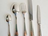 four forks, a spoon, and a knife on a table