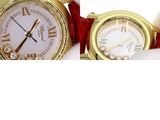 two watches sitting next to each other on a white surface