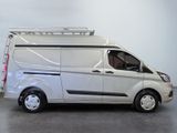 a white van with a ladder on the back of it