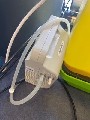 a yellow box with a white hose attached to it and a yellow box with a white hose attached to it and a yellow box with a white hose attached