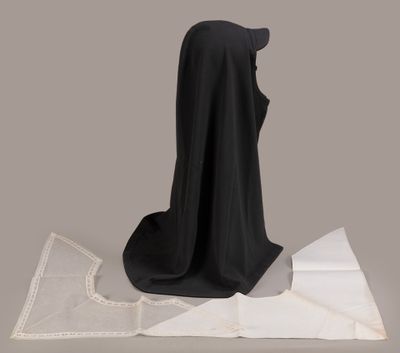 a black cloth on a table next to a piece of paper