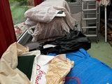 a pile of bags sitting on the back of a truck
