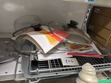 a lot of pots and pans on the shelf in the kitchen