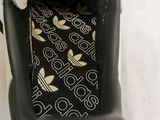 a person that is holding a shoe that has a label on it