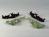 three pieces of green and black hair clips on a white surface