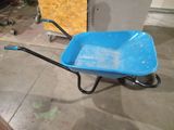 a blue wheelbarrow that is sitting on the floor