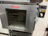 an oven that is sitting in a kitchen with the door open