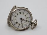 a silver pocket watch with roman numerals on the face