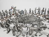 a large group of metal figurines that are arranged in a circle