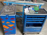 un établi bleu et un chariot de travail bleu dans un entrepôt