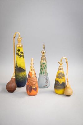 several different colored vases are lined up on a white surface