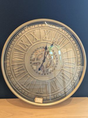 a clock that is sitting on top of a wooden table