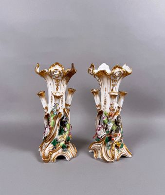 pair of antique porcelain vases with flowers and leaves on them