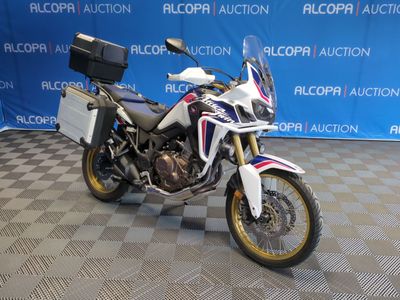 a white and blue motorcycle parked on a checkered floor