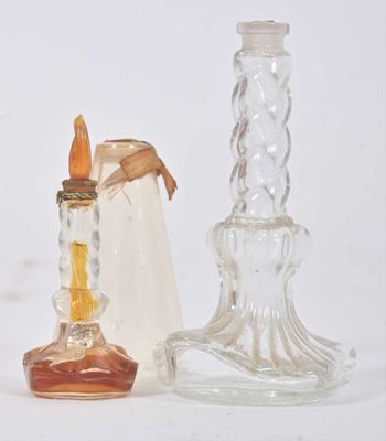 two glass candlesticks and a candle holder on a white surface