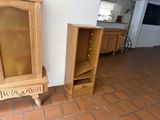 two wooden cabinets in the corner of a room