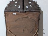 a small wooden cabinet with a clock on top of it