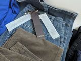 a pile of clothes and a pair of jeans on a table