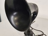 a black lamp that is on a white table