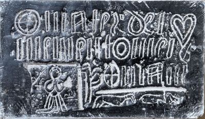 a close up of a metal plaque with writing on it