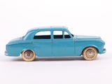 a blue toy car that is sitting on a white surface