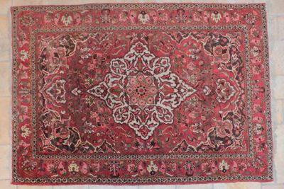 an antique persian rug with a medallion design on a white background