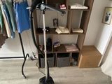 an image of a room with a clothes rack and a hair dryer
