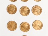 several gold coins are arranged in a triangle on a white surface