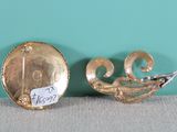 pair of gold plated brooches with a bird on them