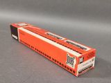 an orange box of toothpaste sitting on top of a gray surface